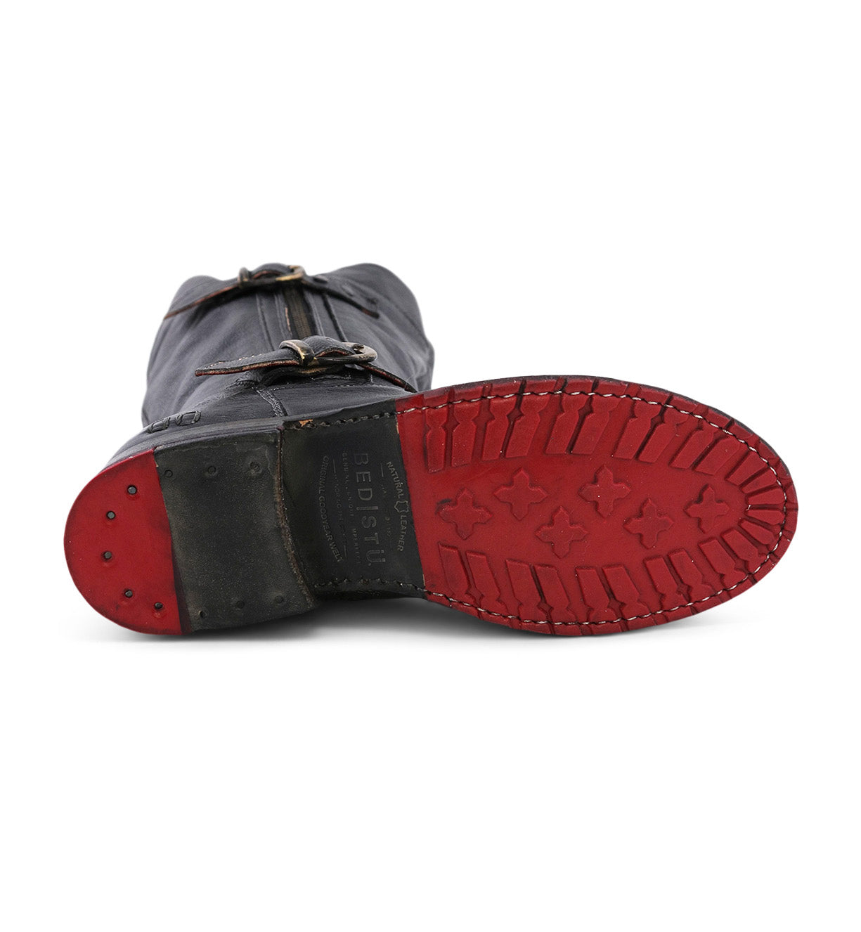 A pair of Bed Stu Gogo Lug Wide Calf boots with red soles.
