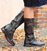 A woman wearing a pair of black leather Bed Stu Gogo Lug Wide Calf boots.