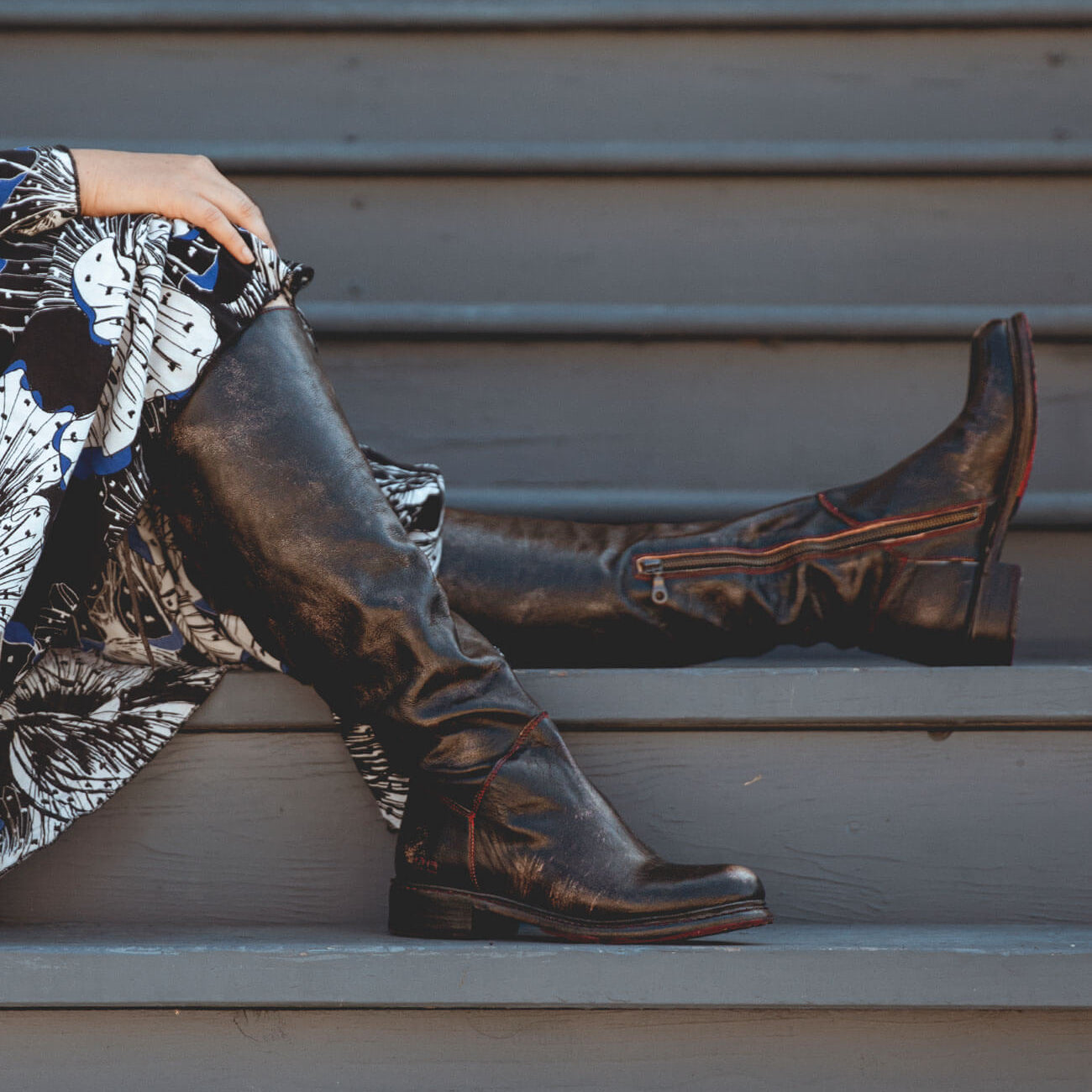 A woman wearing the Bed Stu Manchester Wide Calf and black boots.