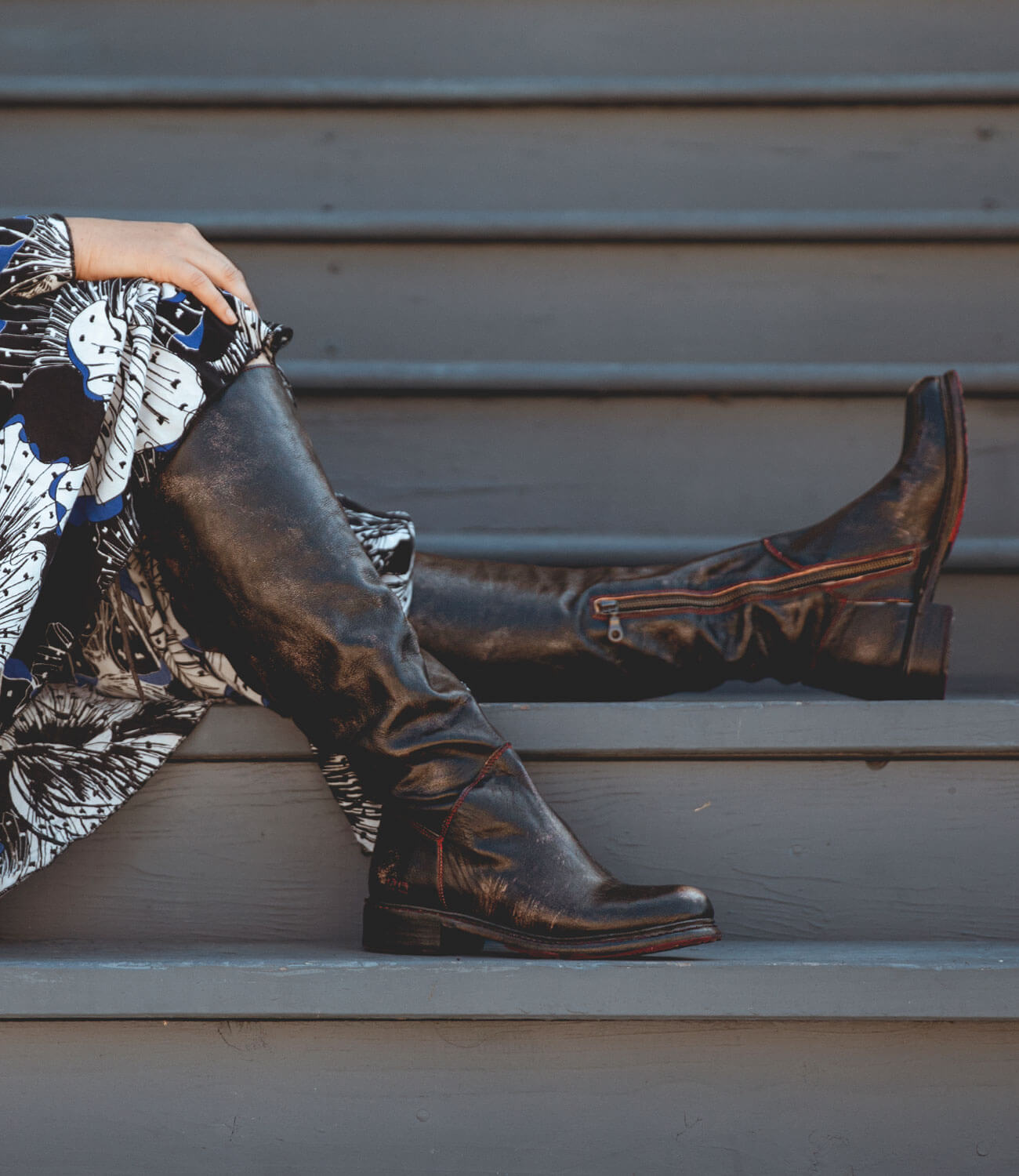 A woman wearing the Bed Stu Manchester Wide Calf and black boots.