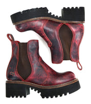 A pair of Bed Stu Valda Hi red leather Chelsea boots with black elastic side panels and thick, treaded platform soles, displayed side by side and upside down.