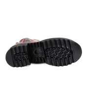 The image showcases the bottom view of a single Bed Stu Valda Hi boot, emphasizing its thick, textured platform sole and detailed tread pattern. The upper section of the Valda Hi boot, partially visible in brown, is also highlighted.