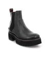 A black leather Valda Hi chelsea boot with a red sole by Bed Stu.