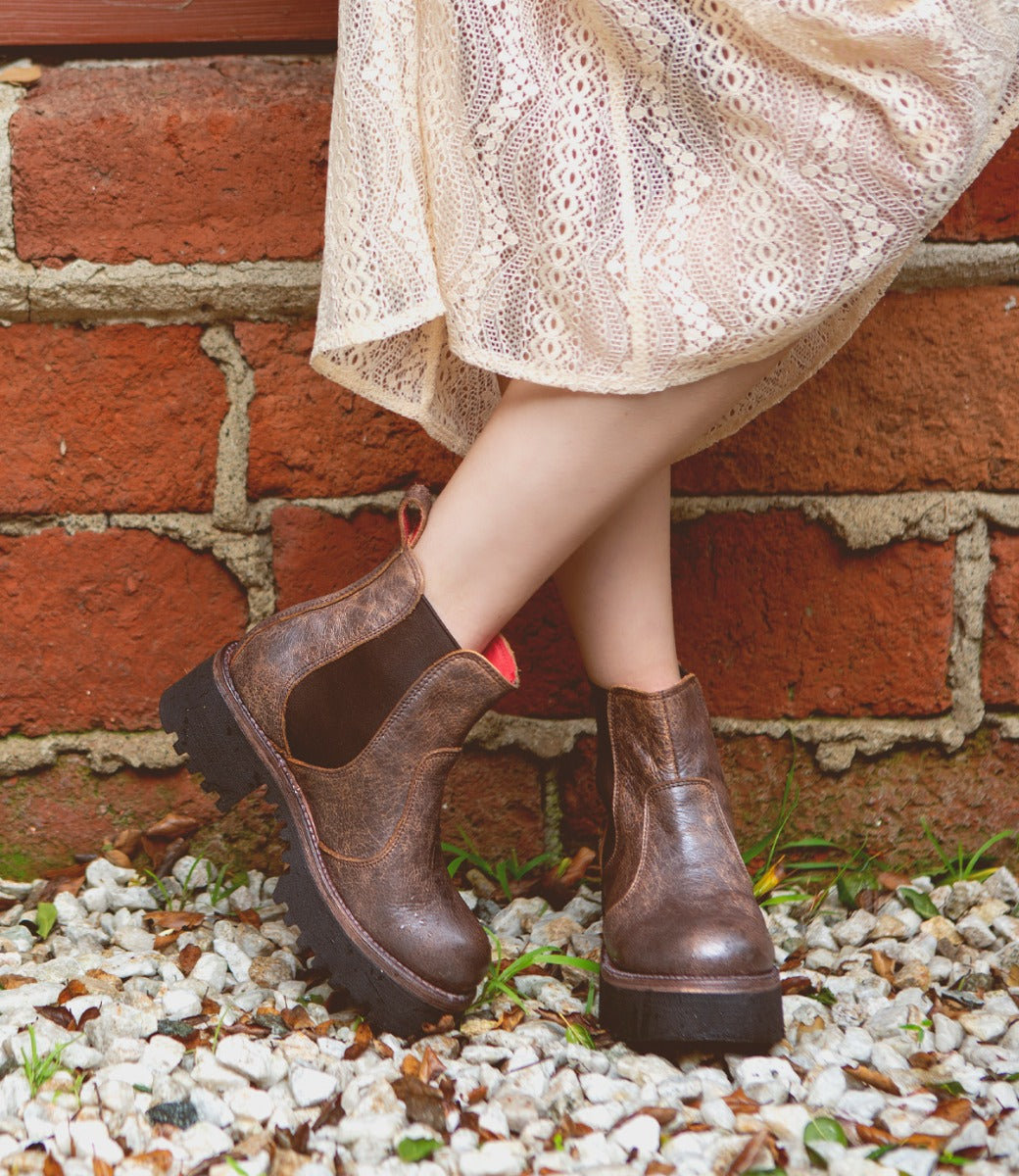 A woman wearing Bed Stu Valda Hi boots and a white dress.