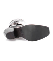 A pair of Vamoose black leather boots on a white background by Bed Stu.