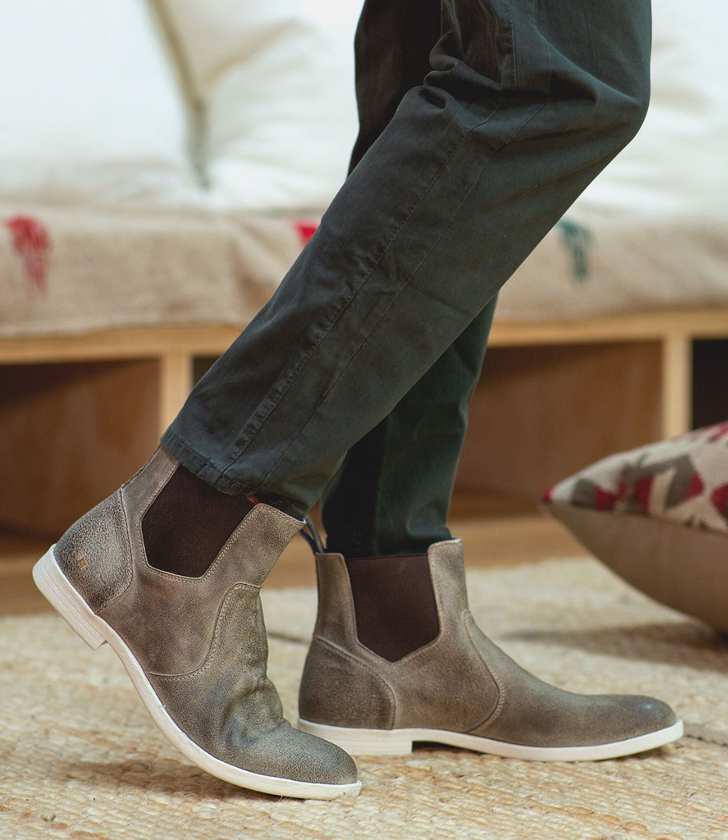 A person standing on a Bed Stu rug.