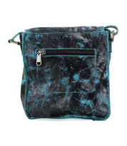 A blue and black marbled leather crossbody bag with a front zipper pocket and an adjustable shoulder strap, the Venice Beach by Bed Stu is a vintage-inspired masterpiece.