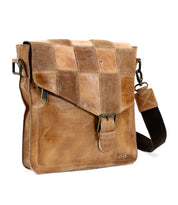 A Venice Beach II messenger bag by Bed Stu, with a checkered front panel, metallic buckles, and an adjustable shoulder strap, isolated on a white background.