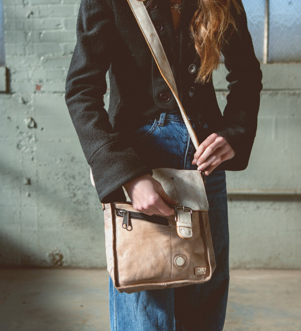 A woman wearing Venice Beach leather messenger bag from Bed Stu.