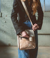A woman wearing Venice Beach leather messenger bag from Bed Stu.