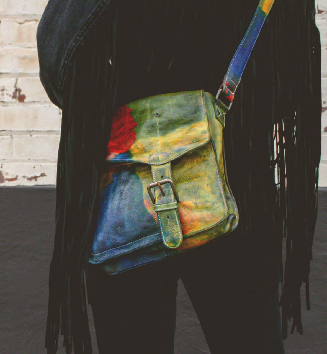 A woman holding a colorful Venice Beach bag by Bed Stu.