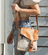 A woman wearing jeans and a Bed Stu Venice Beach cross body bag.