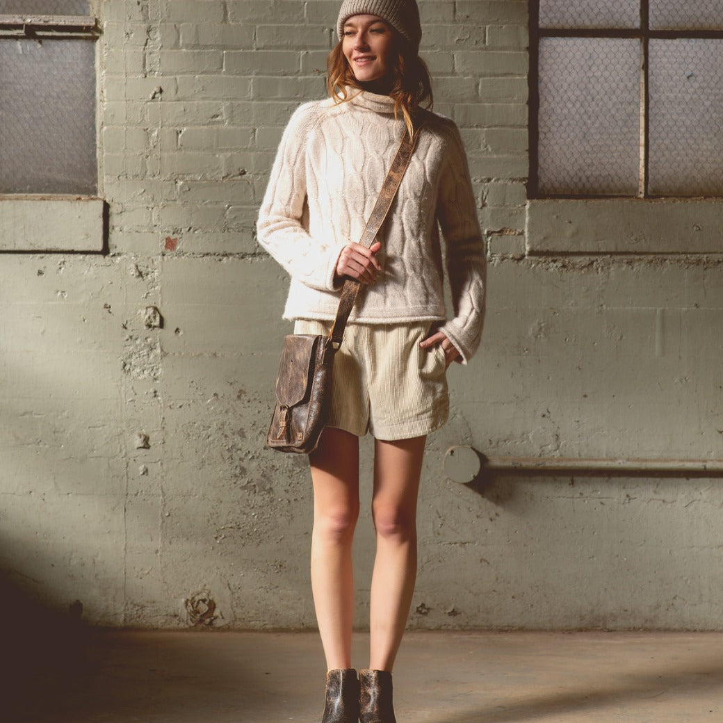 A woman wearing Venice Beach teak pure leather bag from Bed Stu.