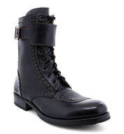 Black Bed Stu Walker vegetable tanned leather combat boot with laces and a buckle at the top, isolated on a white background.