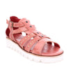 A women's pink sandal with studs and a white sole, called the Wonder by Bed Stu.