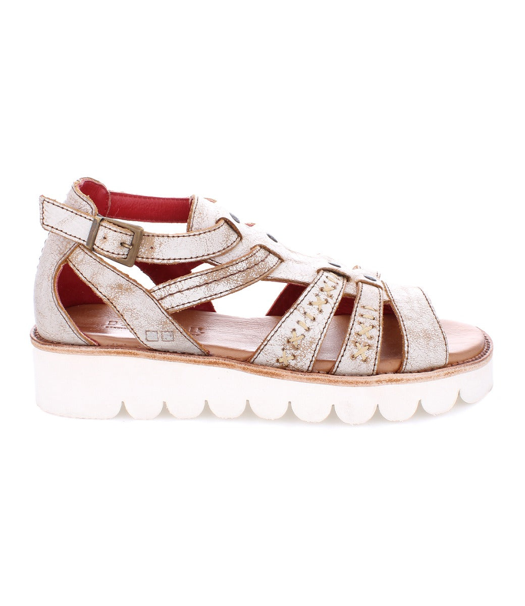 A women's sandal with a white outsole and white straps named "Wonder" by Bed Stu.