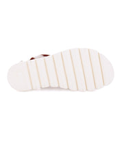 A pair of Wonder sandals from Bed Stu with a red sole.