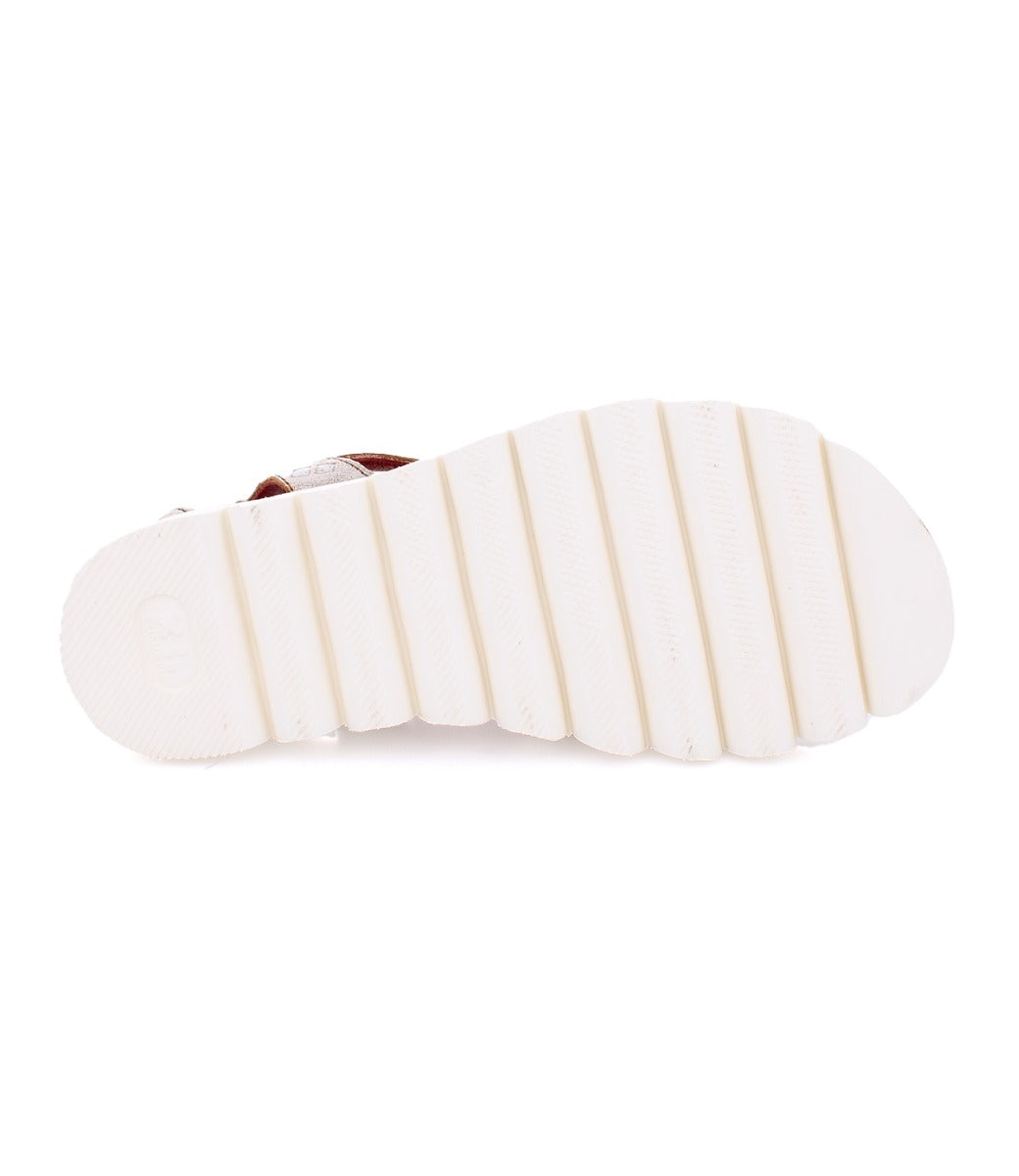A pair of Wonder sandals from Bed Stu with a red sole.