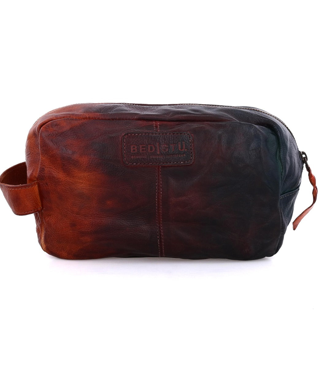 A Yatra brown leather toiletry bag on a white background. Branded Bed Stu.