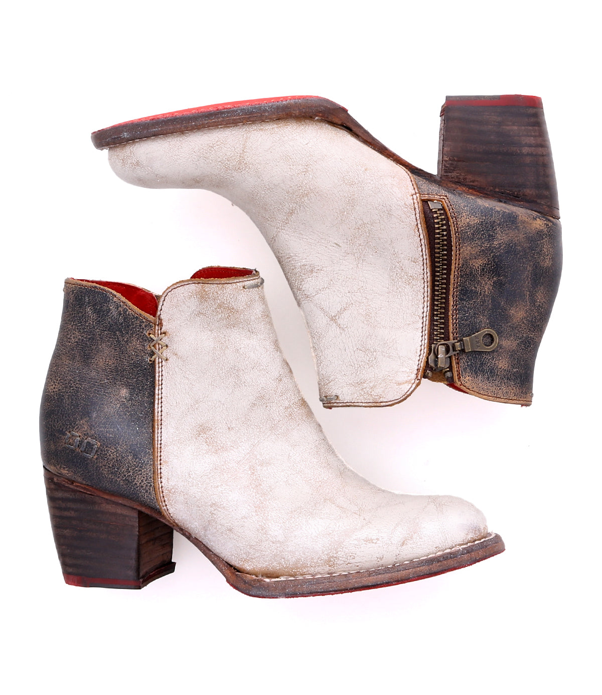 A pair of durable Bed Stu white leather ankle boots on a white background.