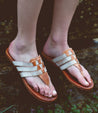 A woman wearing Bed Stu Yoli sandals.