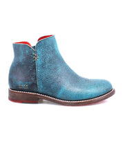 A side view of the Bed Stu Yurisa blue leather ankle boot, featuring a red interior lining, brown sole, and white stitching, showcasing a timeless design.