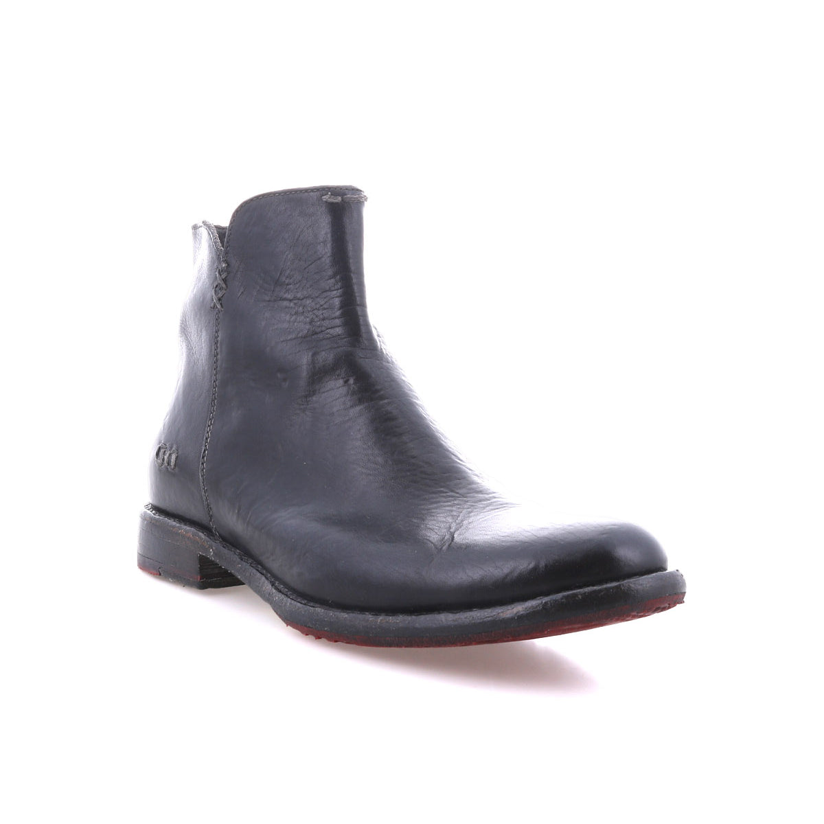 The Bed Stu Yurisa is a black leather ankle boot with a low heel, red leather lining, and side zipper—shown on a white background as the perfect everyday boot.
