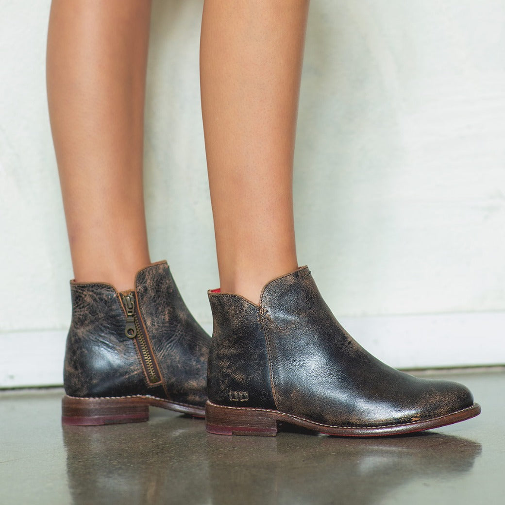 A woman wearing a pair of Yurisa black leather chelsea boots by Bed Stu.