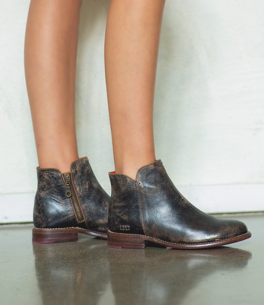 A woman wearing a pair of Yurisa black leather chelsea boots by Bed Stu.