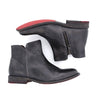 A pair of Yurisa black leather ankle boots with red soles by Bed Stu.