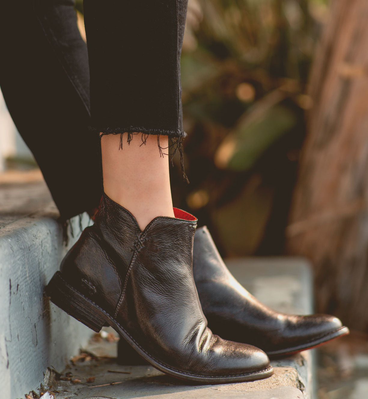 A woman wearing the Yurisa black leather chelsea boots by Bed Stu.