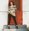 A woman standing on the steps of a door wearing Bed Stu Yurisa chelsea boots.