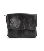 The Bed Stu Ziggy JB is a black leather crossbody bag featuring a flap closure, subtle stitching, and a faint embroidered floral design on the front.