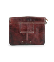The Bed Stu Ziggy JB is a square, dark brown leather crossbody bag featuring visible stitching, a front pocket detail, and a zipper on the top right.