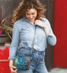 A woman wearing jeans and a blue Bed Stu Ziggy cross body bag.