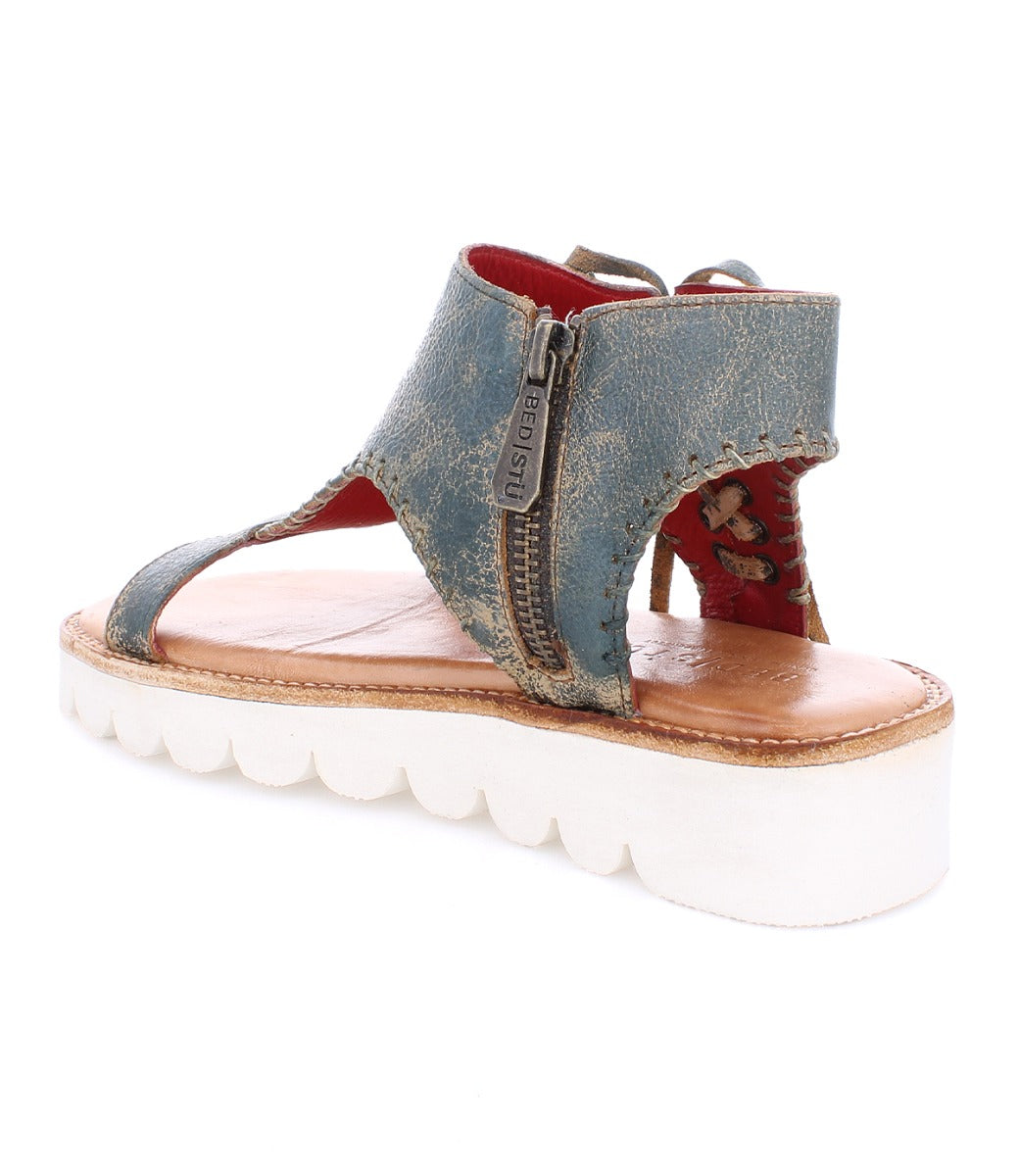 A women's blue and white Bed Stu Zoe II sandal with a zipper.