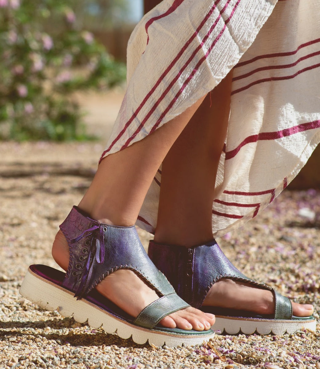A woman's feet in a pair of Bed Stu Zoe II sandals.