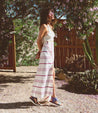 A woman wearing a Bed Stu Zoe II striped maxi skirt and sandals.